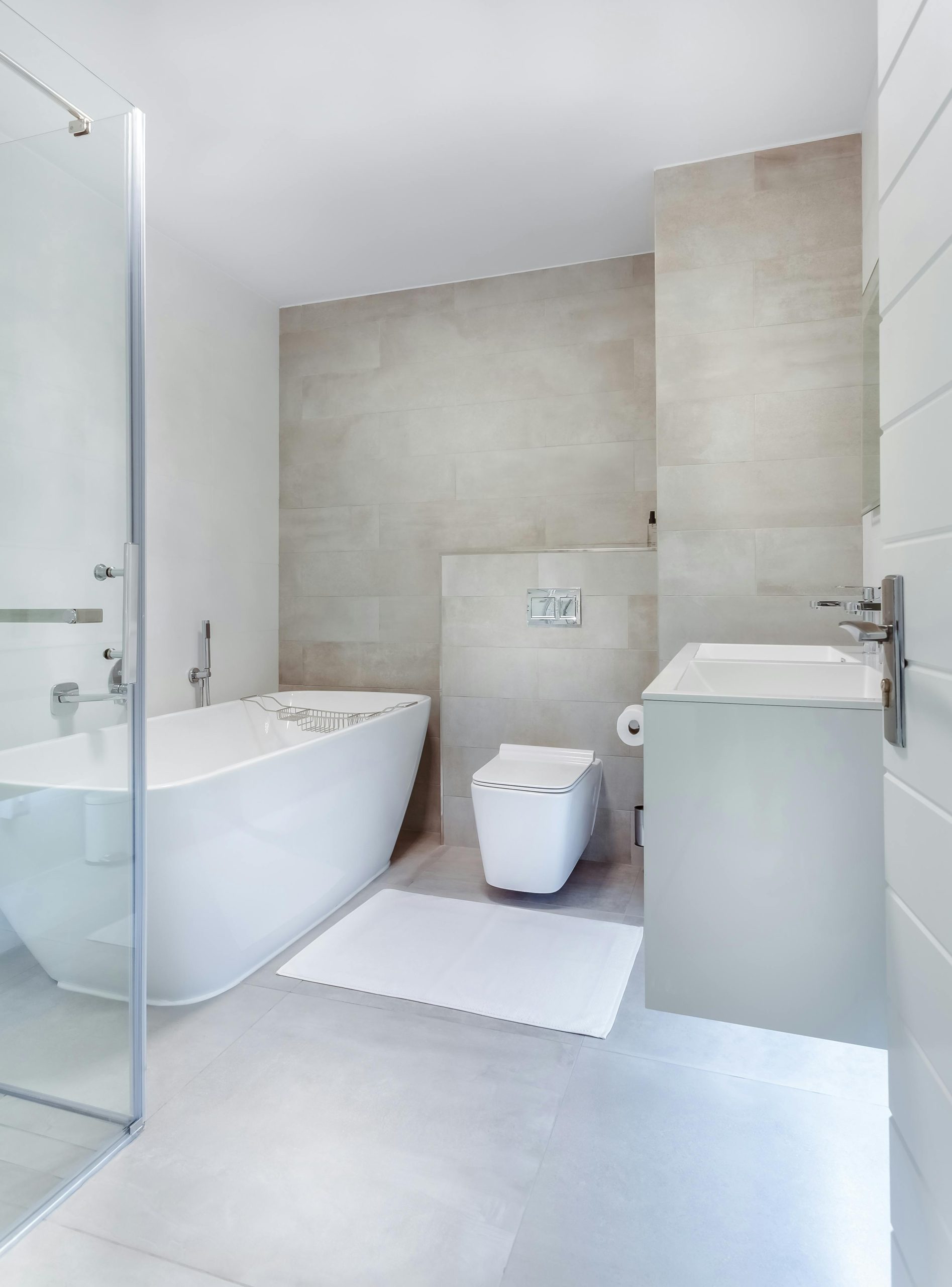 Home Elegant minimalistic bathroom featuring bathtub and sleek fixtures.
